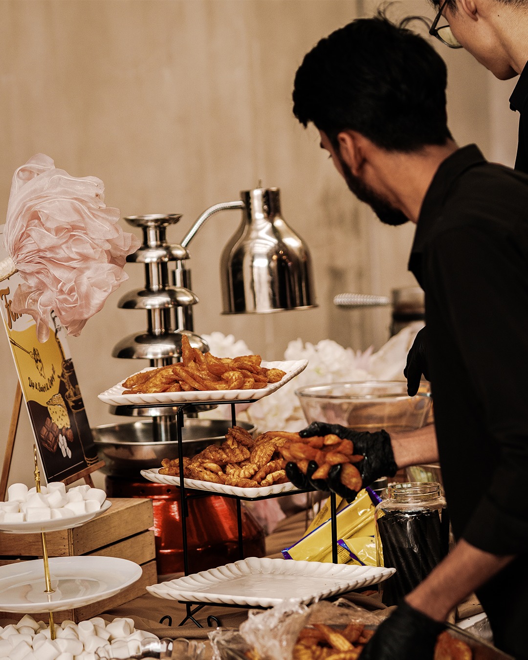 Catering staff arranging dessert station